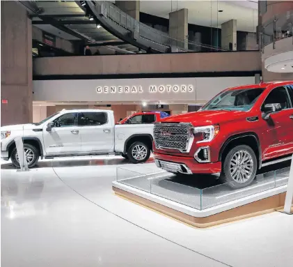  ??  ?? This file photo shows a GMC Sierra pickup, left, and Denali in Detroit last month. General Motors’ posted an $8.1 billion net profit last year as it got better prices for vehicles sold in the U.S., its most lucrative market. AP PHOTO