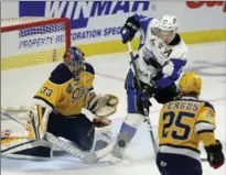  ?? ADRIAN WYLD, THE CANADIAN PRESS ?? Otters goaltender Troy Timpano goes down to block a shot while Sea Dogs centre Matthew Highmore tries to tip the puck past him.