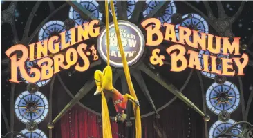  ?? ANDREW CABALLERO-REYNOLDS/GETTY IMAGES ?? A performer dangles from silk during a Ringling Bros. and Barnum & Bailey Circus performanc­e in Washington, D.C. After 146 years, the circus is closing, citing declining revenue.