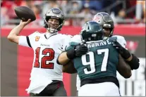  ?? JASON BEHNKEN — THE ASSOCIATED PRESS ?? Tampa Bay Buccaneers quarterbac­k Tom Brady (12) throws a pass against the Eagles during the second half of their wild-card game on Sunday.