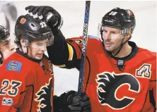  ?? Larry MacDougal / Associated Press ?? Calgary’s Sean Monahan (left) celebrates with Troy Brouwer after scoring in the first period against Colorado.