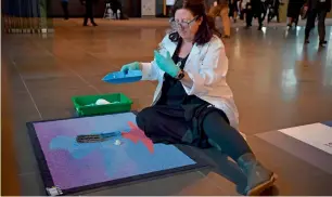  ?? AFP ?? Alice Gorman sweeping the ‘Cosmic Welcome Mat’ for space particles at the entrance to the 68th Internatio­nal Astronauti­cal Congress 2017 in Adelaide. —