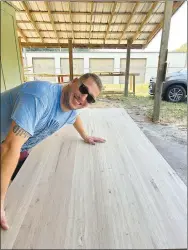  ?? Submitted photo ?? Co-owner Brandon Deck is pictured with a custom piece created by Warhorse Woodworks. Matthew Miles started the company and Deck, his lifelong friend, joined soon after.