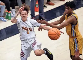  ?? BRYAN TERRY/THE OKLAHOMAN ?? PC North’s Zander Baker passes the ball as tries to get past PC West’s Kaidon Rayfield during a game on Feb. 10.