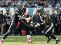  ?? CHRIS SZAGOLA — THE ASSOCIATED PRESS ?? A sight from Sunday’s win over the Vikings that Doug Pederson would like to see more of in the future: Eagles quarterbac­k Carson Wentz handing the ball off to a running back, in this case, Darren Sproles. Pederson said Monday he hopes to not ask Wentz...