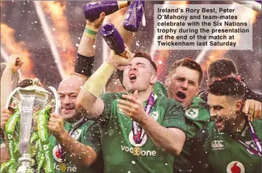  ??  ?? Ireland’s Rory Best, Peter O’Mahony and team-mates celebrate with the Six Nations trophy during the presentati­on at the end of the match at Twickenham last Saturday