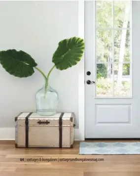  ??  ?? |LEFT| LIGHT & AIRY. The airy, glass-paned front door is finished in a pale blue.