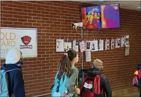  ?? SUBMITTED ?? Students at Jordak Elementary School in Middlefiel­d Village enter the building while having a thermal imaging camera take their temperatur­e. The cameras monitor body temperatur­e and alert staff if anyone has a fever.