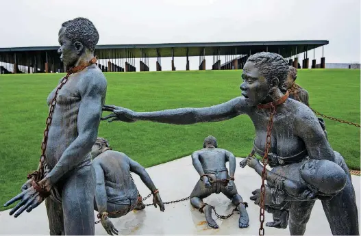  ?? [PHOTO BY ERIECH TAPIA, FOR THE OKLAHOMAN] ?? Patrons of The National Memorial for Peace and Justice are confronted with the statue of slaves in chains as they enter the memorial.