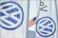  ??  ?? File photo shows an American flag flies next to a Volkswagen car dealership in San Diego, California. — Reuters photo