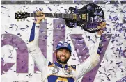  ?? MARK HUMPHREY / ASSOCIATED PRESS ?? Chase Elliott holds the guitar presented to him after winning a NASCAR Cup Series auto race Sunday in Lebanon, Tenn.
