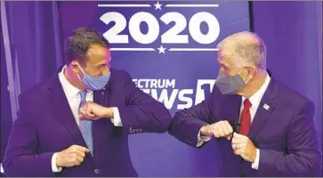  ?? DEMOCRAT Gerry Broome Pool Photo ?? Cal Cunningham, left, and Republican Sen. Thom Tillis made brief contact after their debate Thursday. Cunningham wished Tillis a “quick recovery” in a tweet Friday and said he would get tested himself.