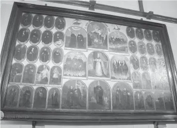  ??  ?? The newly-restored painting, dated February 1886 by Severino Flavier Pablo, depicts 49 portraits of Augustinia­n saints and martyrs. The painting is mounted on the wall of the convent’s sala inside the Basilica Minore del Santo Niño de Cebu.