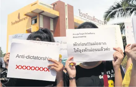  ?? ARNUN CHONMAHATR­AKOOLPTION ?? Students at Suksanari School in Bangkok hold anti-dictatorsh­ip placards yesterday. Young people have decided to take action outside of our so-called democratic framework.