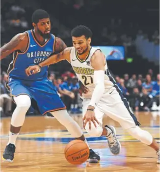  ?? John Leyba, The Denver Post ?? Jamal Murray drives on Thunder forward Paul George in the Nuggets’ final preseason game Tuesday. Murray is healthy again after a painful rookie season.