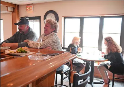  ?? SARAH GORDON/THE DAY ?? June Sylvia of Old Lyme laughs at her husband, Mark, as they eat lunch at Hideaway Restaurant & Pub in Old Lyme on Sunday.