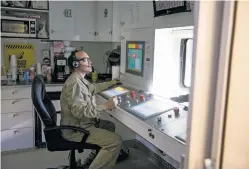  ?? ILANA PANICH-LINSMAN/THE NEW YORK TIMES ?? Thomas Perley, a hydraulic fracturing operator and pump controller, works earlier this month in Midland, Texas. At a Pioneer Natural Resources frack site, controller­s sit inside a room in order to frack. As in other industries, automation is creating a...