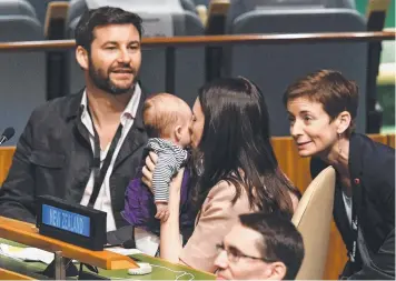  ?? Picture: AFP ?? WORLD STAGE: NZ Prime Minister Jacinda Ardern kisses daughter Neve as husband Clarke Gayford looks on during the Nelson Mandela Peace Summit at the UN in New York yesterday.