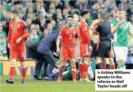  ??  ?? &gt; Ashley Williams speaks to the referee as Neil Taylor heads off