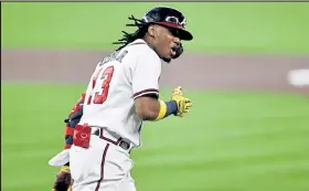  ?? Elsa / Getty Images ?? The Braves’ Ronald Acuna Jr. celebrates his leadoff home run during the first inning of Game 1 of the National League Division Series against the Marlins at Minute Maid Park in Houston.