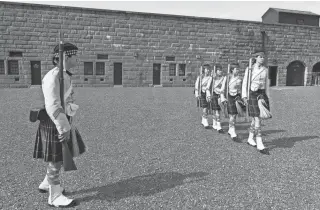  ?? ?? A drill team wearing Scottish kilts marches at the Halifax Citadel in eastern Canada. Nova Scotia, which means “New Scotland” in Latin, has a deep historic and cultural connection to Scotland.