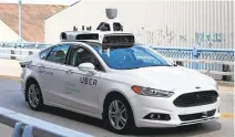  ?? JARED WICKERHAM/ASSOCIATED PRESS ?? A self-driving Ford Fusion goes through a test run in Pittsburgh. Uber will make self-driving cars available there in the coming weeks.