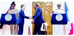  ?? AP ?? France’s President Emmanuel Macron (left) shakes hands with Kenya’s President Uhuru Kenyatta after their press conference at State House in Nairobi, Kenya, on Wednesday, March 13.