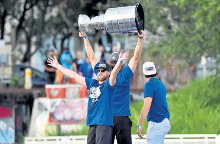  ?? Julio Aguilar, Getty Images ?? Steven Stamkos celebrates as Victor Hedman hoists the Stanley Cup up next to Luke Schenn of the Tampa Bay Lightning during the Victory Rally & Boat Parade on the Hillsborou­gh river on September 30 Tampa, Fla.