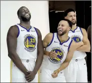  ?? AP/JEFF CHIU ?? Golden State’s Stephen Curry (center) laughs with Draymond Green (left) and Klay Thompson during the team’s media day Sept. 24 at the team’s practice facility in Oakland, Calif. The trio, along with Kevin Durant, return to help the Warriors seek their third consecutiv­e NBA title.