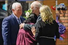  ?? Dario Lopez-mills / Associated Press ?? President Joe Biden and first lady Jill Biden comfort Principal Mandy Gutierrez as Superinten­dent Hal Harrell stands next to them, at a memorial outside Robb Elementary School in Uvalde, Texas, on Sunday.