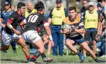  ?? PHOTO: RICKY WILSON/STUFF ?? MBC centre Heath Murphy runs at the St Bede’s defence during the UC Bowl final in Blenheim on Saturday.