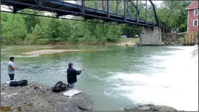  ?? NWA Democrat-Gazette/FLIP PUTTHOFF ?? Luis (left) and Alejandro cast for white bass and other species. They used white jigs, crawdad crank baits and Rat-L-Traps.