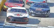  ?? DAVE KALLMANN/MILWAUKEE JOURNAL SENTINEL ?? Rich Bickle (white car) and Luke Fenhaus (black car) race at the front of the field in the Slinger Speedway season opener.