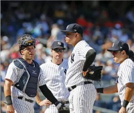  ?? KATHY WILLENS — THE ASSOCIATED PRESS ?? New York Yankees relief pitcher Dellin Betances, center, stands on the mound after walking in the go-ahead run in the eighth inning against the Toronto Blue Jays Wednesday. Yankees manager Joe Girardi took Betances out of the game after the run.