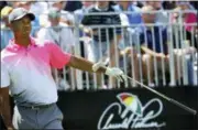  ?? JOE BURBANK — ORLANDO SENTINEL VIA AP ?? Tiger Woods points to his left after driving wide on his first tee-off to start his the second round of the Arnold Palmer Invitation­al golf tournament Friday in Orlando, Fla.