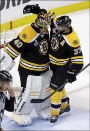  ?? AP Photo ?? Bruins center Patrice Bergeron (37) congratula­tes goalie Tuukka Rask on his shutout after the Bruins beat the Blackhawks 2-0 in Game 3 of the Stanley Cup Final Monday in Boston.