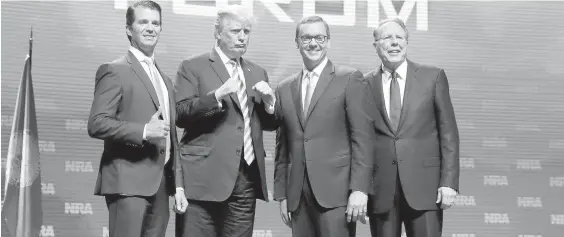  ??  ?? Donald Trump Jr., left, U.S. President Donald Trump, National Rifle Associatio­n executive director Chris Cox and NRA CEO Wayne LaPierre in Dallas on Friday.