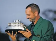  ?? DAVID GOLDMAN/THE ASSOCIATED PRESS ?? Sergio Garcia of Spain admires his trophy at the green jacket ceremony after winning the Masters tournament Sunday in Augusta, Ga.