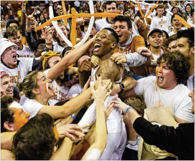  ?? NICK WAGNER / AMERICAN-STATESMAN ?? Texas’ Kerwin Roach II celebrates with the student section in February after UT topped Oklahoma. The Big 12 got seven teams, including Texas, into the field of 68. Oklahoma made the cut; Baylor and Oklahoma State did not.