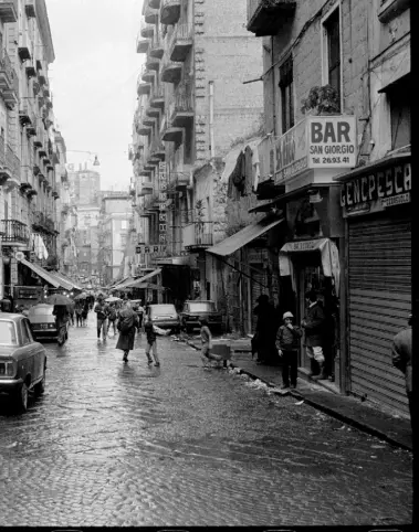  ??  ?? As in her acclaimed four-part novel series, the city of Naples, pictured left in the Eighties, reprises its role as the backdrop to Elena Ferrante’s latest story, The Lying Life of Adults