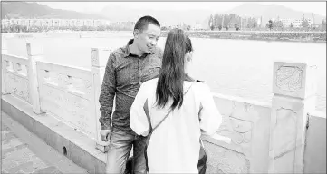  ??  ?? Cheng Zhu, 43, talks to his daughter Cheng Ying, 16, on the banks of the Tian River in China’s Hubei province. Ying, who asked for her face not to be revealed, was kidnapped by child trafficker­s at the age of five and only reunited with her family when...