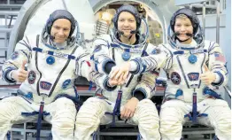  ?? AP ?? From left: CSA astronaut David Saint Jacques, Russian cosmonaut Оleg Kononenko and US astronaut Anne McClain pose for a photo before their final preflight practical examinatio­n in a mock-up of a Soyuz space craft at Russian Space Training Center in Star City, outside Moscow, Russia in 2018.