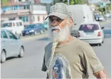  ??  ?? A man with a beard stands in a street of Havana.