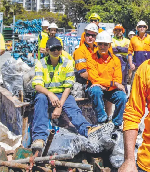  ??  ?? CFMEU member Scott Vink leads a chant against Gold Coast Mayor Tom Tate at the $1.4b Ruby site in Surfers Paradise yesterday. Below some of the 150 workers and (right) the Mayor shrugs it off and addresses media. Pictures: JERAD WILLIAMS