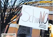  ?? CALVIN ?? A Tennessee fan holds a sign Sunday during a gathering of fans reacting to the possibilit­y of hiring Ohio State defensive coordinato­r Greg Schiano, inset, for its head coaching vacancy, in Knoxville, Tenn.