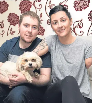  ?? Picture: Steven Brown. ?? Molly, back home after 12 days away, with Sean Nobile and Robyn Ferguson at their home in Dunfermlin­e.