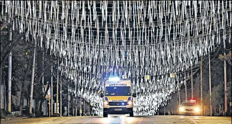  ?? AFP ?? An ambulance is on the move under lighting put up for Christmas celebratio­ns, during a night-time Covid-19 curfew in Tbilisi, Georgia.