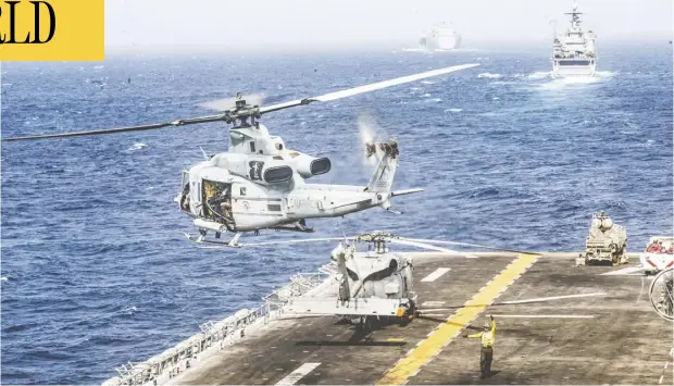  ?? DALTON SWANBECK/U.S. NAVY/HANDOUT VIA REUTERS ?? A U.S. Marines UH-1Y Venom helicopter takes off from the flight deck of the U.S. Navy’s USS Boxer in the Strait of Hormuz on Thursday. The Pentagon says the Boxer brought down an Iranian drone that approached the amphibious assault ship on Thursday, but Iran denies the claim.