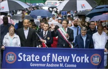  ?? CRAIG RUTTLE — ASSOCIATED PRESS ?? New York Gov. Andrew Cuomo, center right, joins others on Fifth Avenue during the annual Columbus Day Parade in New York on Monday.