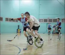  ?? PETER SEARLE, TNS ?? Centre-floor action at a unicycle hockey game in Minnesota. Goalies have the toughest job.